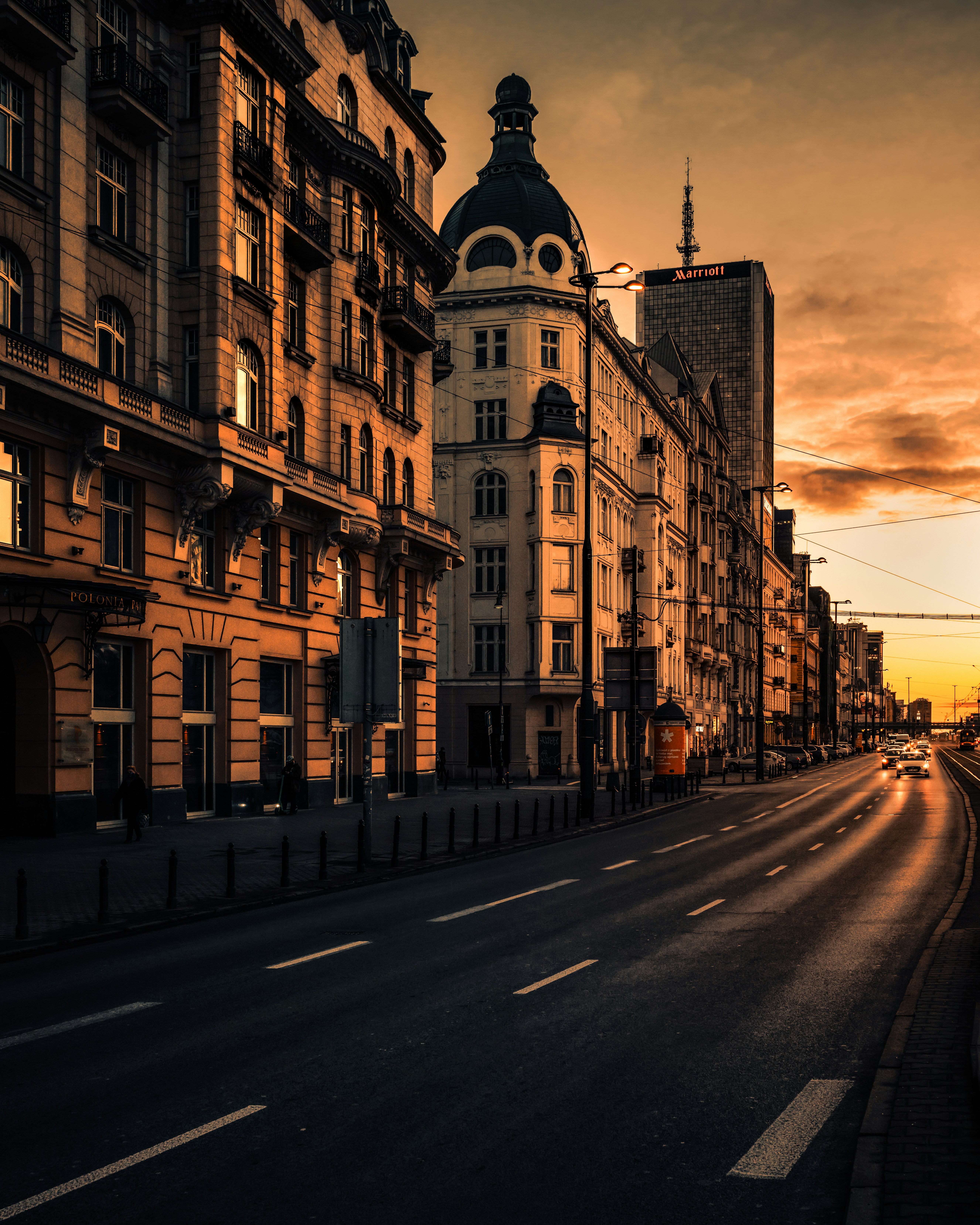 brown concrete building beside road during daytime